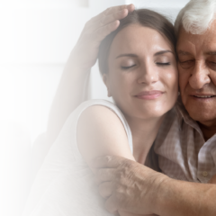 Adult daughter embracing her father with dementia